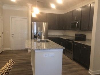 Sleek granite countertops in kitchen and baths